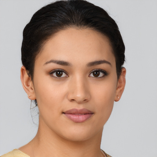 Joyful latino young-adult female with medium  brown hair and brown eyes