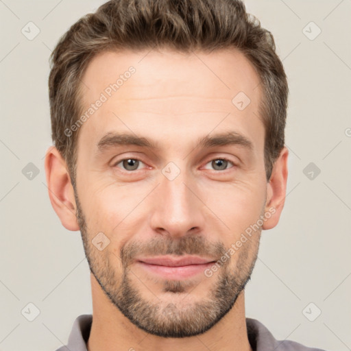 Joyful white young-adult male with short  brown hair and brown eyes