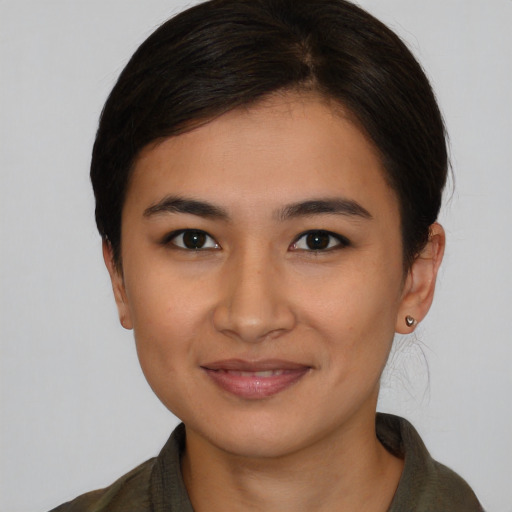 Joyful latino young-adult female with short  brown hair and brown eyes