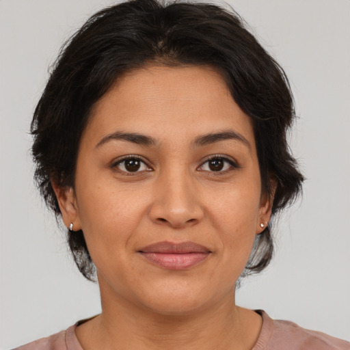 Joyful asian adult female with medium  brown hair and brown eyes