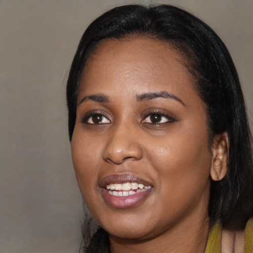 Joyful black young-adult female with medium  black hair and brown eyes