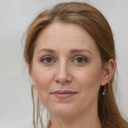 Joyful white adult female with long  brown hair and brown eyes