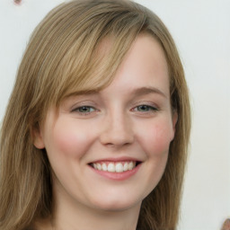 Joyful white young-adult female with long  brown hair and green eyes