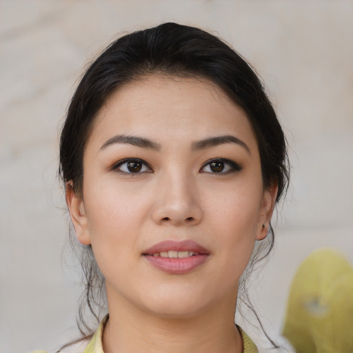 Joyful asian young-adult female with medium  brown hair and brown eyes