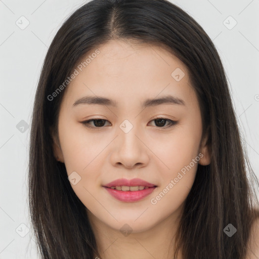 Joyful asian young-adult female with long  brown hair and brown eyes