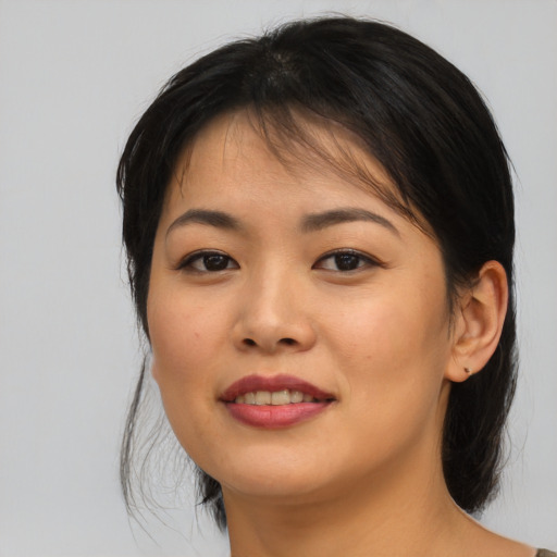 Joyful asian young-adult female with medium  brown hair and brown eyes