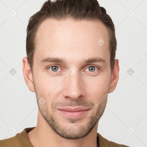 Joyful white young-adult male with short  brown hair and grey eyes