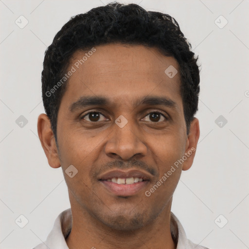 Joyful black young-adult male with short  black hair and brown eyes