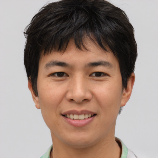 Joyful asian young-adult male with short  brown hair and brown eyes