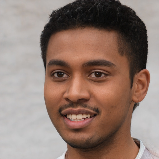 Joyful black young-adult male with short  black hair and brown eyes