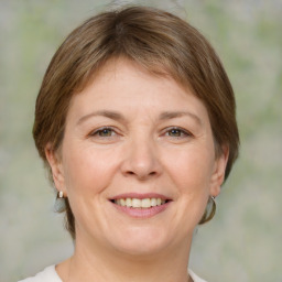 Joyful white adult female with medium  brown hair and brown eyes