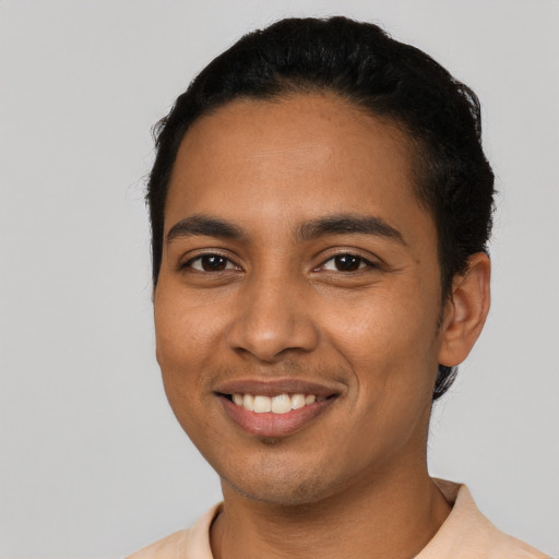 Joyful latino young-adult male with short  black hair and brown eyes