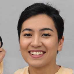 Joyful asian young-adult female with medium  black hair and brown eyes