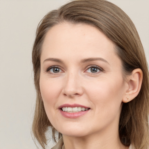 Joyful white young-adult female with medium  brown hair and brown eyes