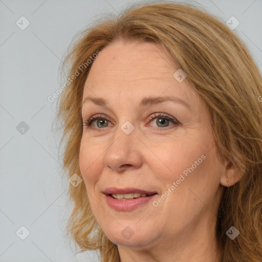 Joyful white adult female with long  brown hair and brown eyes