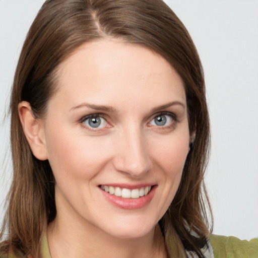 Joyful white young-adult female with medium  brown hair and grey eyes