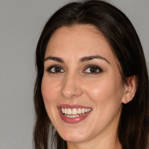 Joyful white adult female with long  brown hair and brown eyes