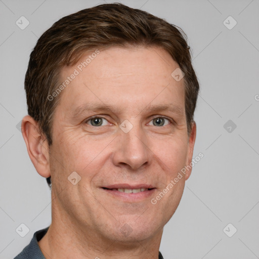 Joyful white adult male with short  brown hair and grey eyes