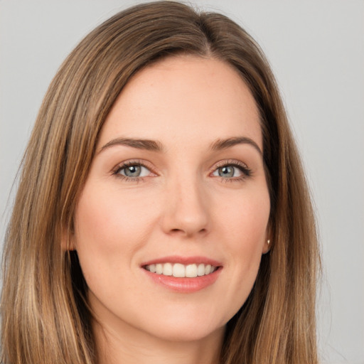 Joyful white young-adult female with long  brown hair and brown eyes