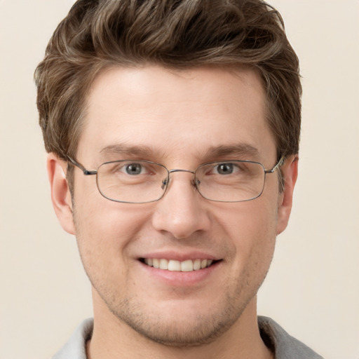 Joyful white adult male with short  brown hair and grey eyes