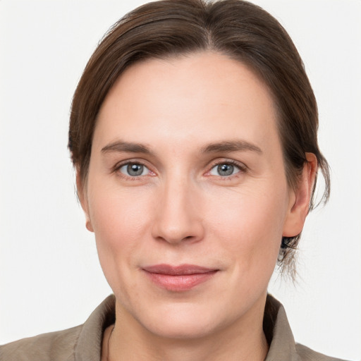 Joyful white young-adult female with medium  brown hair and grey eyes