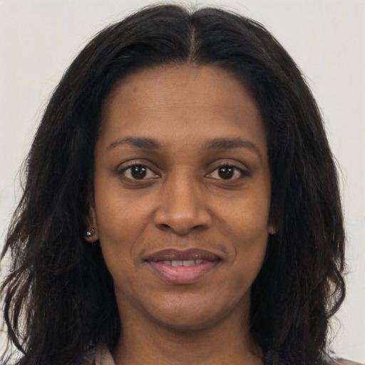 Joyful black young-adult female with long  black hair and brown eyes