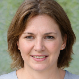 Joyful white adult female with medium  brown hair and brown eyes