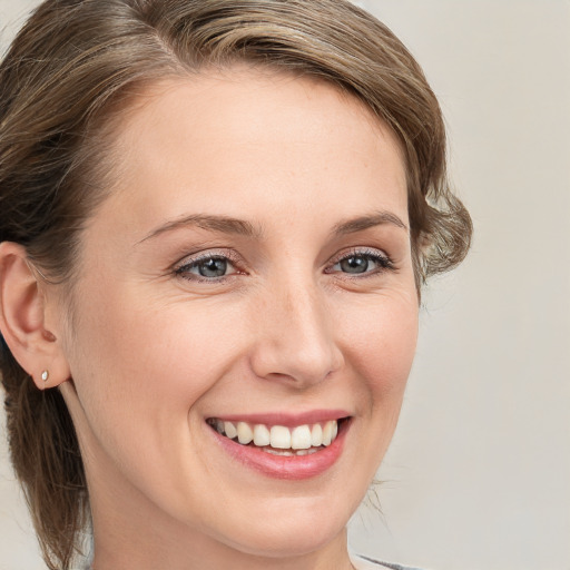 Joyful white young-adult female with medium  brown hair and blue eyes