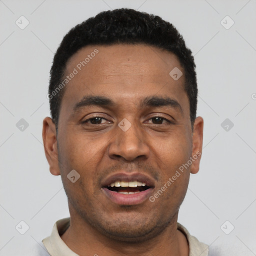 Joyful black young-adult male with short  black hair and brown eyes