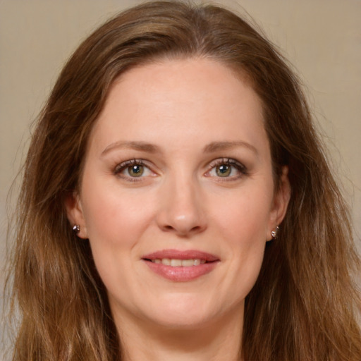 Joyful white young-adult female with long  brown hair and green eyes