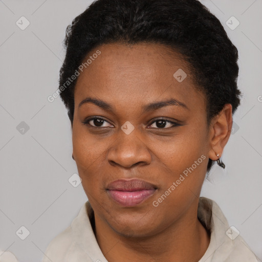 Joyful black young-adult female with short  black hair and brown eyes