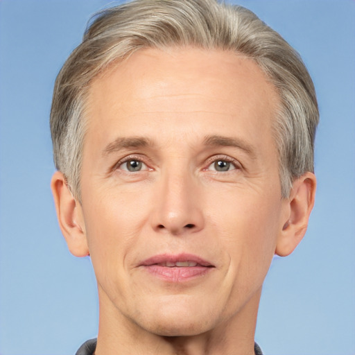 Joyful white adult male with short  blond hair and brown eyes