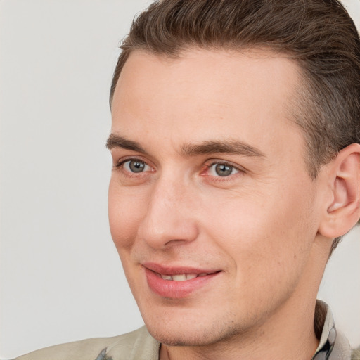 Joyful white young-adult male with short  brown hair and grey eyes