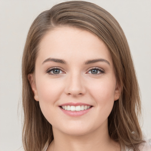 Joyful white young-adult female with long  brown hair and grey eyes