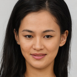 Joyful asian young-adult female with long  brown hair and brown eyes