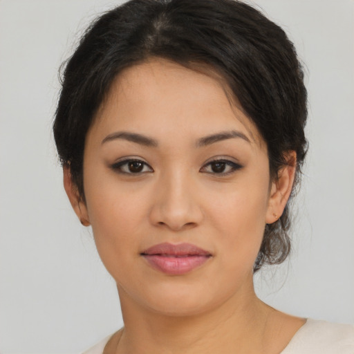 Joyful latino young-adult female with medium  brown hair and brown eyes