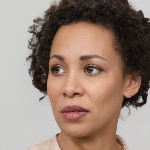 Joyful black young-adult female with medium  brown hair and brown eyes