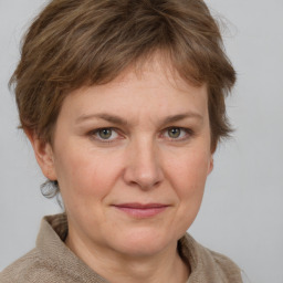 Joyful white adult female with medium  brown hair and grey eyes