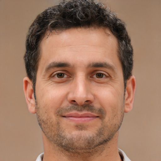 Joyful white adult male with short  brown hair and brown eyes