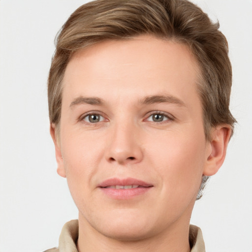 Joyful white young-adult male with short  brown hair and grey eyes