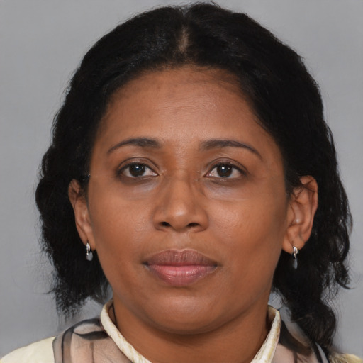 Joyful black adult female with medium  brown hair and brown eyes