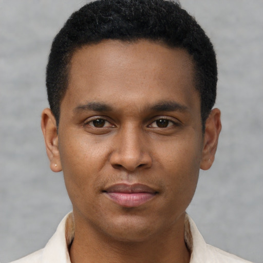 Joyful latino young-adult male with short  brown hair and brown eyes