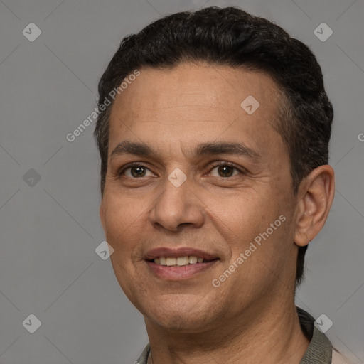 Joyful white adult male with short  black hair and brown eyes