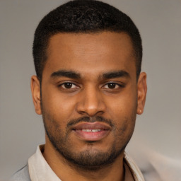 Joyful latino young-adult male with short  brown hair and brown eyes