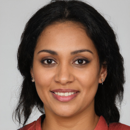 Joyful latino young-adult female with long  black hair and brown eyes