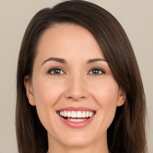 Joyful white young-adult female with long  brown hair and brown eyes