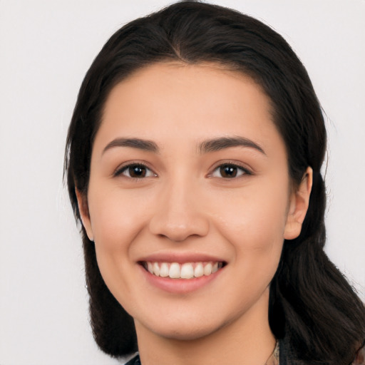 Joyful white young-adult female with long  black hair and brown eyes