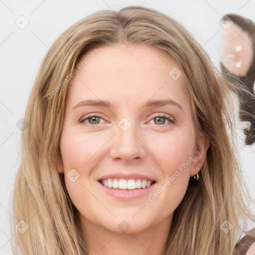 Joyful white young-adult female with long  brown hair and blue eyes