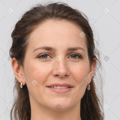 Joyful white adult female with long  brown hair and brown eyes