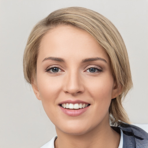 Joyful white young-adult female with medium  brown hair and grey eyes